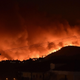 Flames rise from a fire spreading around Kapandriti, a town on the outskirts of Athens, Greece, on August 5, 2021.